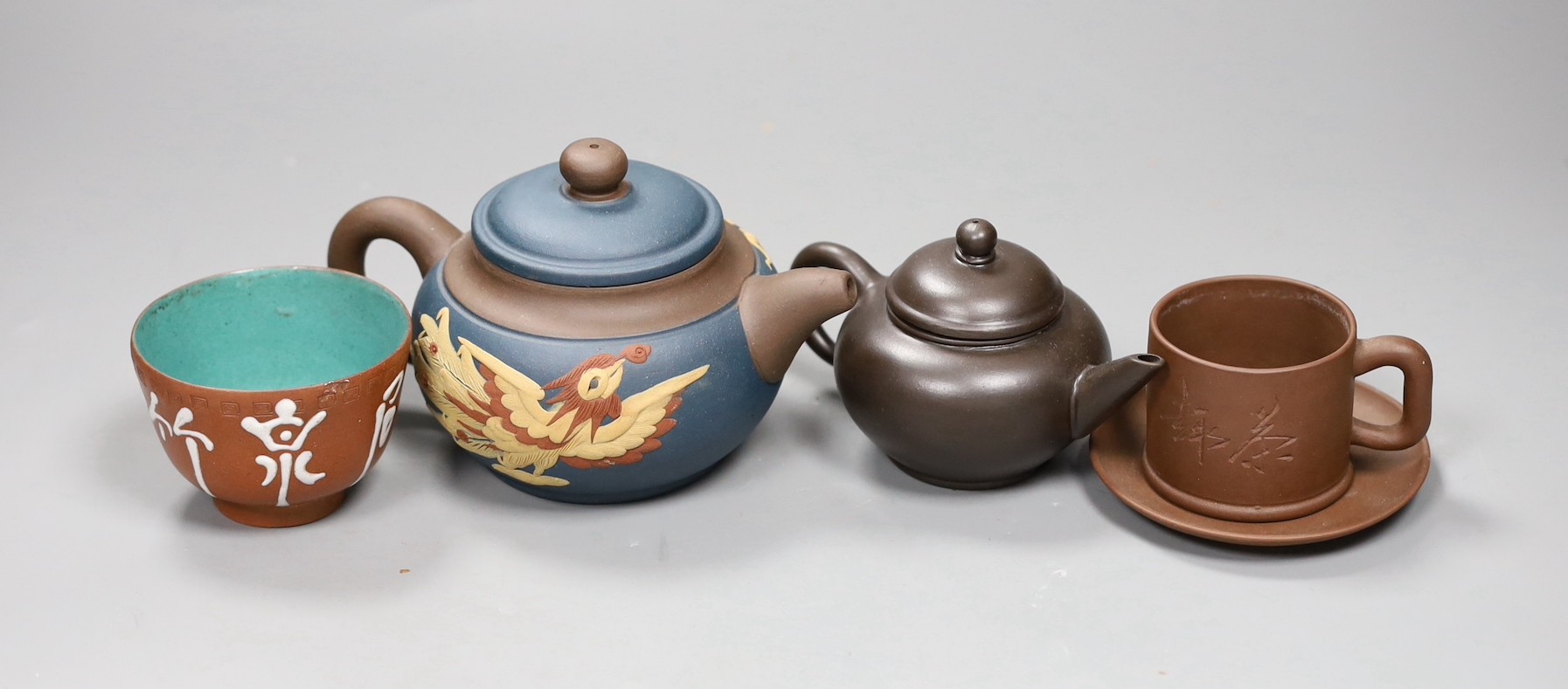 A 19th century Chinese Yixing cup, two later teapots and a cup and saucer